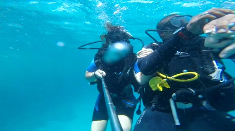 People diving under the warm cyan water. Stock Footage 62534885
