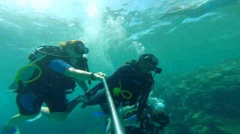 People diving under the warm cyan water. Stock Footage 62548815