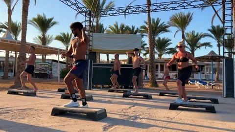 People do step aerobics with the resort's animation team Stock Footage 288044126