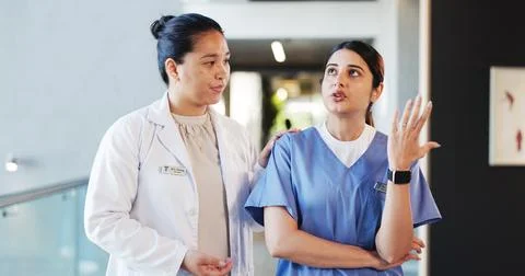 People, doctors and talking with concern in hospital for staff shortage, tr.. Stock Photos