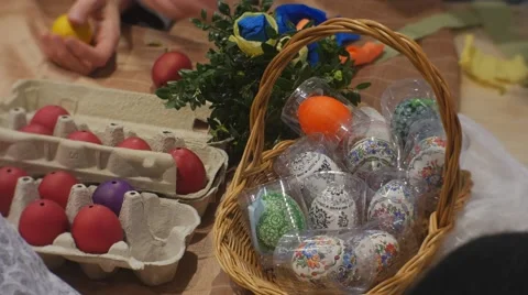 People Doing Easter Eggs Bascket of Colored Eggs on Table Stock Footage 61335281
