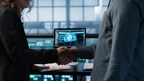 People doing handshake in AI based server farm, checking files, doing deal Stock Photos