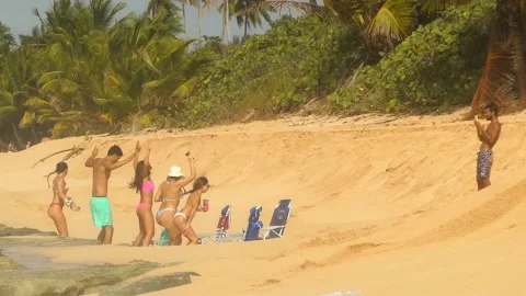 People doing Jumping Jacks on The Beach Stock Footage 130982416