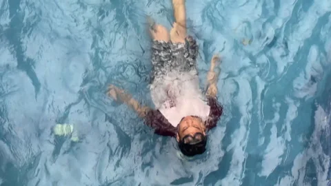 People doing reverse swim at local pool Stock Footage 255693615