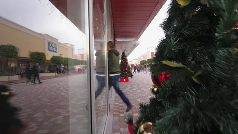 People doing shopping in a large open mall at Christmas with Xmas decoration Stock Footage 99296813