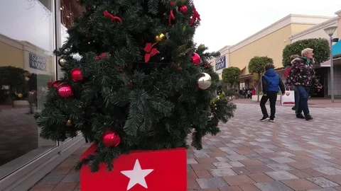 People doing shopping in a large open mall at Christmas with Xmas decoration Stock Footage 99296837
