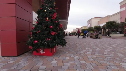 People doing shopping in a large open mall at Christmas with Xmas decoration Stock Footage 99296877