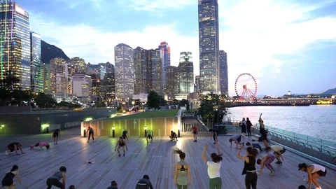 People doing workout in Tamar Park, Hong Kong 動画素材 124987327