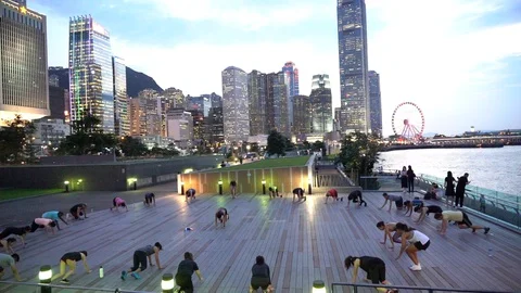 People doing workout in Tamar Park, Hong Kong Stock Footage 124987361