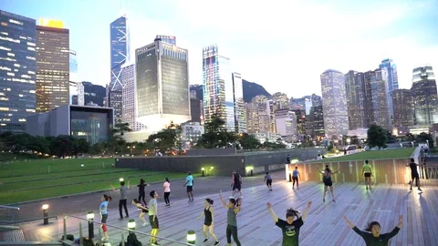 People doing workout in Tamar Park, Hong Kong 動画素材 124987367