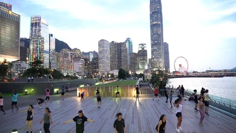 People doing workout in Tamar Park, Hong Kong Stock Footage 124987368