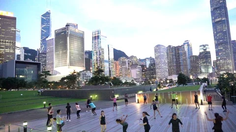 People doing workout in Tamar Park, Hong Kong 動画素材 124987371