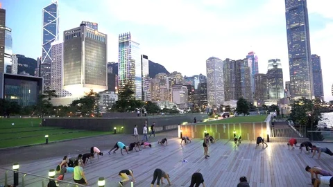 People doing workout in Tamar Park, Hong Kong Stock Footage 124987378