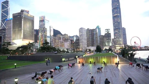 People doing workout in Tamar Park, Hong Kong Stockbeeldmateriaal 124987402