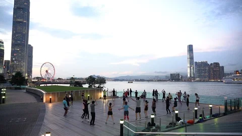 People doing workout in Tamar Park, Hong Kong Stock Footage 124987407