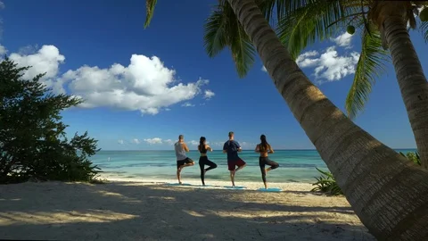 People Doing Yoga On White Sand Beaches of Tulum Stock Footage