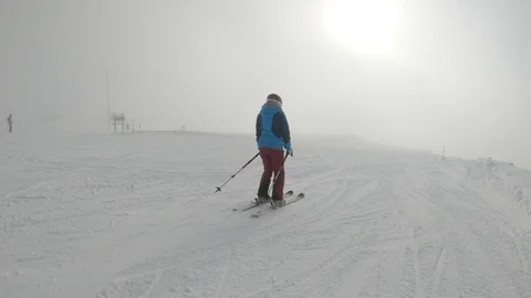 People downhill skiing fast down a snowy white slope. Ylläs Lapland Finland Stock Footage 104873770