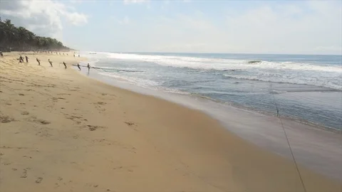 People dragging fish net on Mandoukou beach Stock Footage 97980916