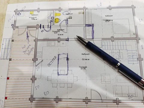 People draw a plan of an apartment or house on a piece of paper. Stock Photos