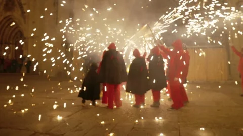 People dressed as demons dancing with fireworks during a traditional Stock Footage 328338181