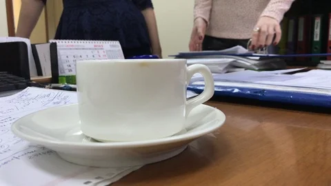 People drink coffee from a white cup in the office Video stock 106575331