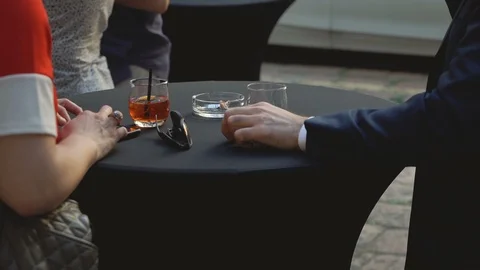 People drinking around table using the phones Video stock 109067770