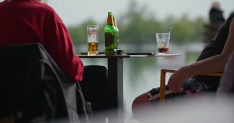 People drinking beer at outdoor table 스톡 동영상 332622069