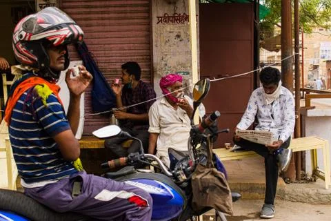 People drinking chai/tea on a tea stall in the middle of the market Stock Photos