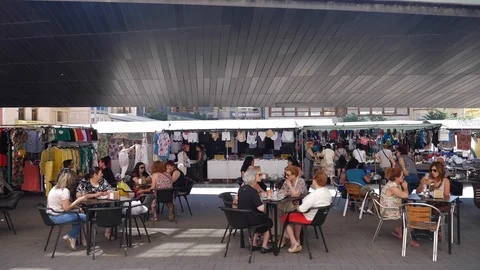 People drinking coffee and refreshments on the terrace of a bar Stockbeeldmateriaal 106092253