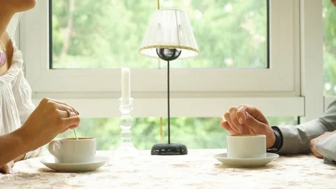 People drinking coffee in cafe, closeup of couple hands with cups Stock Footage 78652019