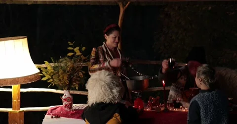 People drinking mulled wine outdoors at night with blurry Christmas lights Stock Footage 165077726