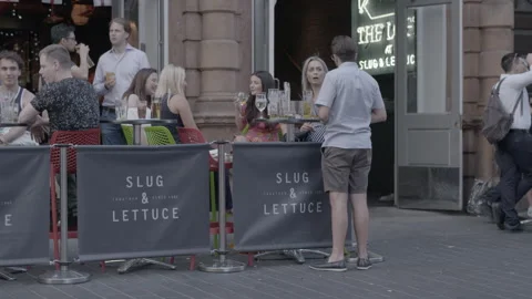 People Drinking Outside a Pub Terrace on a Warm Evening Stock Footage 344618429