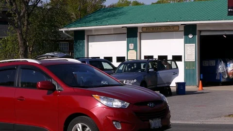 People dropping off electronics at city recycling depot Stock Footage 89904038