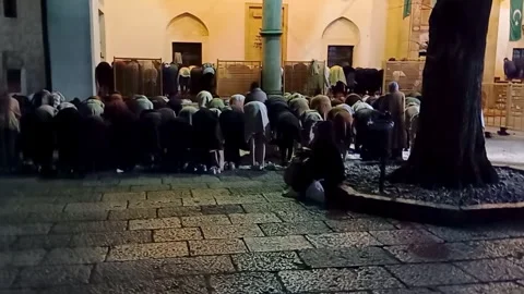 People during night pray inside mosque courtyard  at Bascarsija in Sarajevo. Video stock 246825611