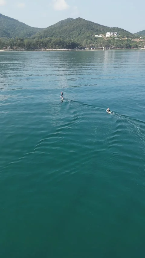 People E Foiling and Riding a Jet Ski in the Ocean in Koh Phangan, Thailand Stock Footage 335815465