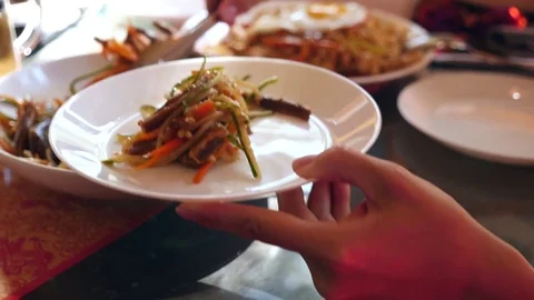 People eat Chinese food in a Chinese restaurant. close-up. Slow motion Stock Footage