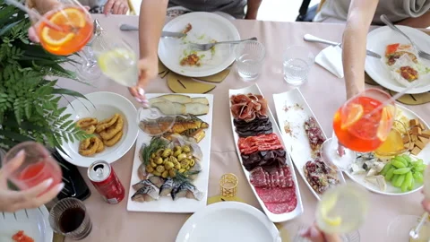 People eating at a large festive table and clink glasses Stock Footage 284713530