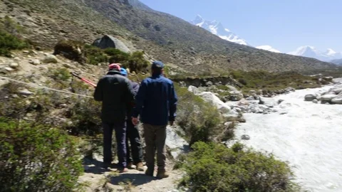 People at the edge of a stream fixing a rope Stock Footage 77450004