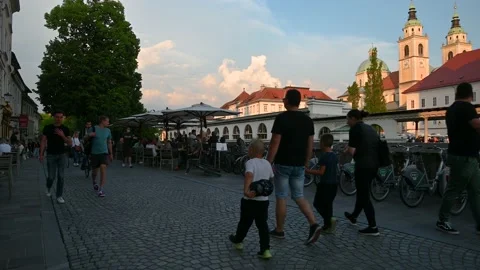 People either standing or walking on cobblestone street in Ljubljana, Slovenia Stock Footage 155881393