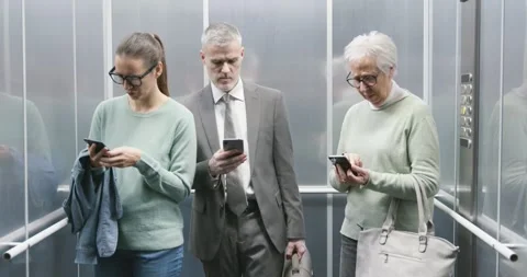 People in the elevator using their smartphones and ignoring others 库存影片 306149822