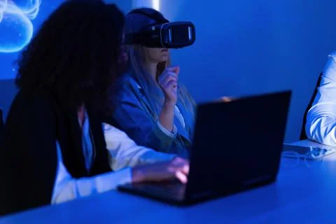 People engaged in virtual reality experience at a tech conference during an.. Stock Photos