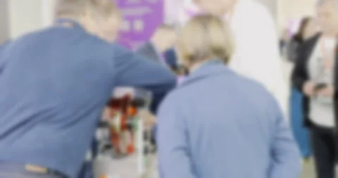 People engaging with interactive exhibit at a busy event Stock Footage 293020208