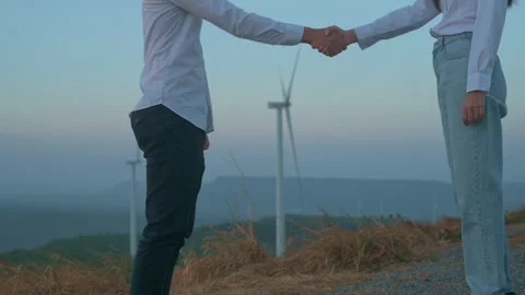 People engineer are shaking hand in a field  wearing a protective helmet Stock Footage 149060848