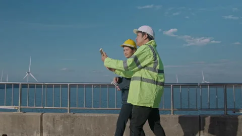People engineer are wearing a protective helmet on head, using tablet Analyti Video stock 169238888