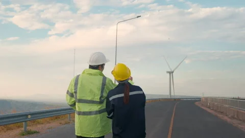 People engineer are wearing a protective helmet on head, using tablet Analyti Stock Footage 169239820