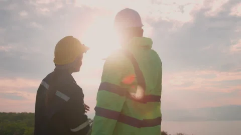 People engineer are wearing a protective helmet on head, using tablet Analyti Stock Footage 169240082
