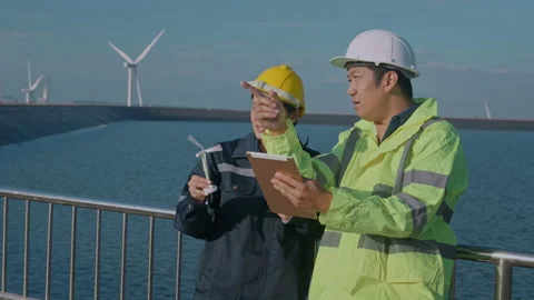 People engineer are wearing a protective helmet on head, using tablet Analyti 動画素材 169240286