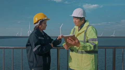 People engineer are wearing a protective helmet on head, using tablet Analyti Stock Footage 169240965