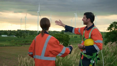 People engineer are wearing a protective helmet on head, talking to each ot.. Stock Footage 269098082