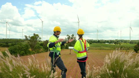 People engineer are wearing a protective helmet on head, talking to each ot.. Stock Footage 269098143
